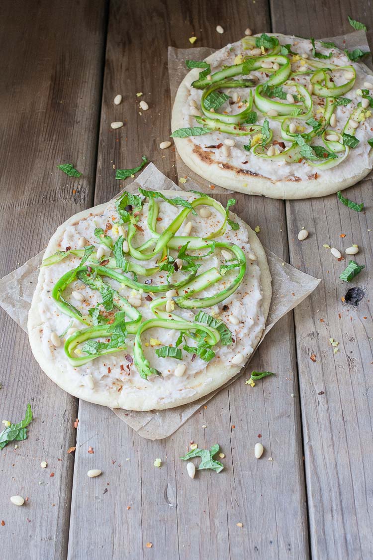 A side shot of an asparagus flatbread with white bean puree