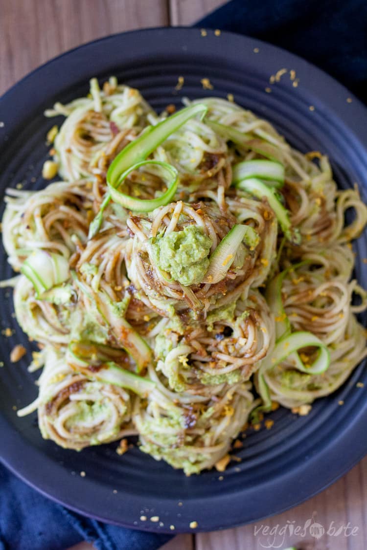 An overhead shot of vegan asparagus pesto over on a black plate