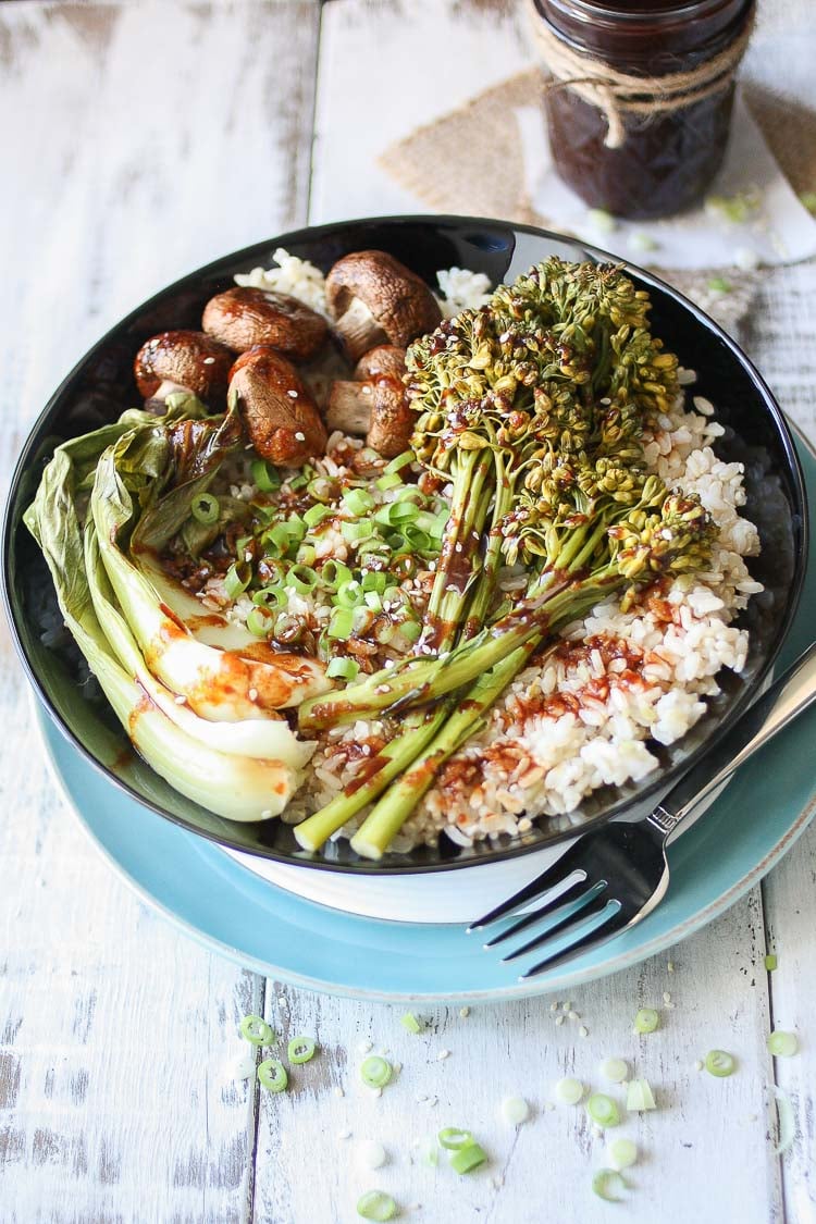 An overhead shot of a Teriyaki Rice Bowl with Roasted Veggies drizzled with sauce 