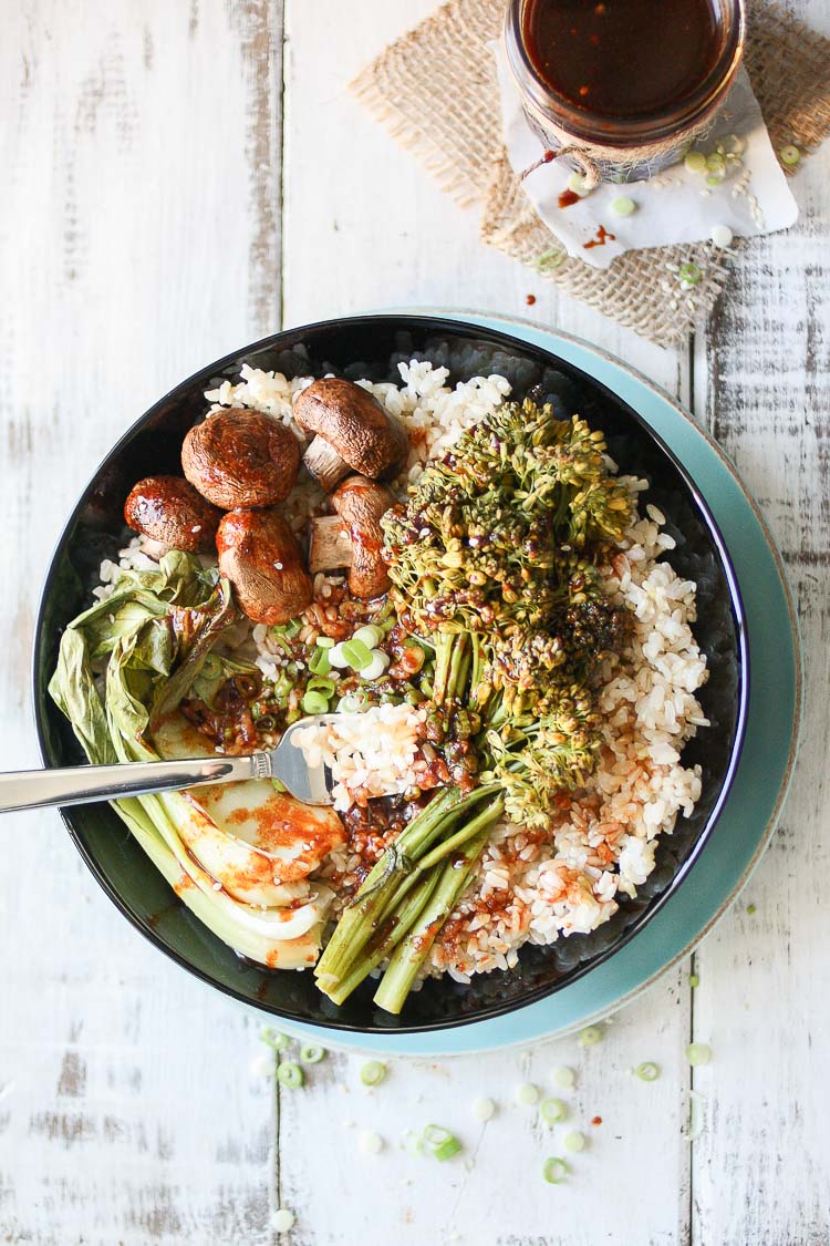 An overhead shot of a Teriyaki Rice Bowl with Roasted Veggies sitting on a wooden surface