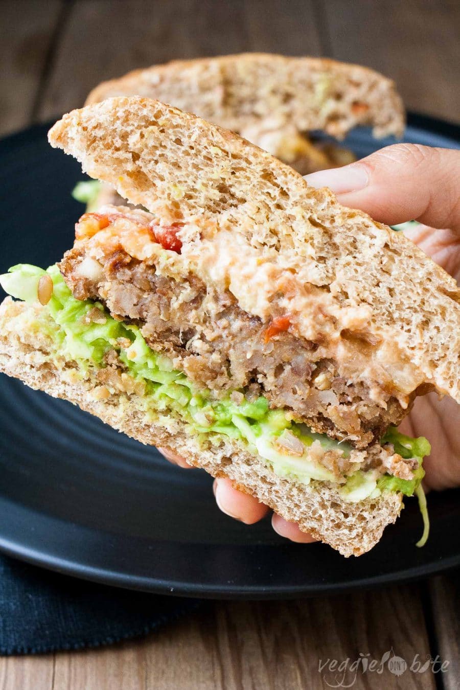 A close up shot of a a vegan lack bean burger cut in half