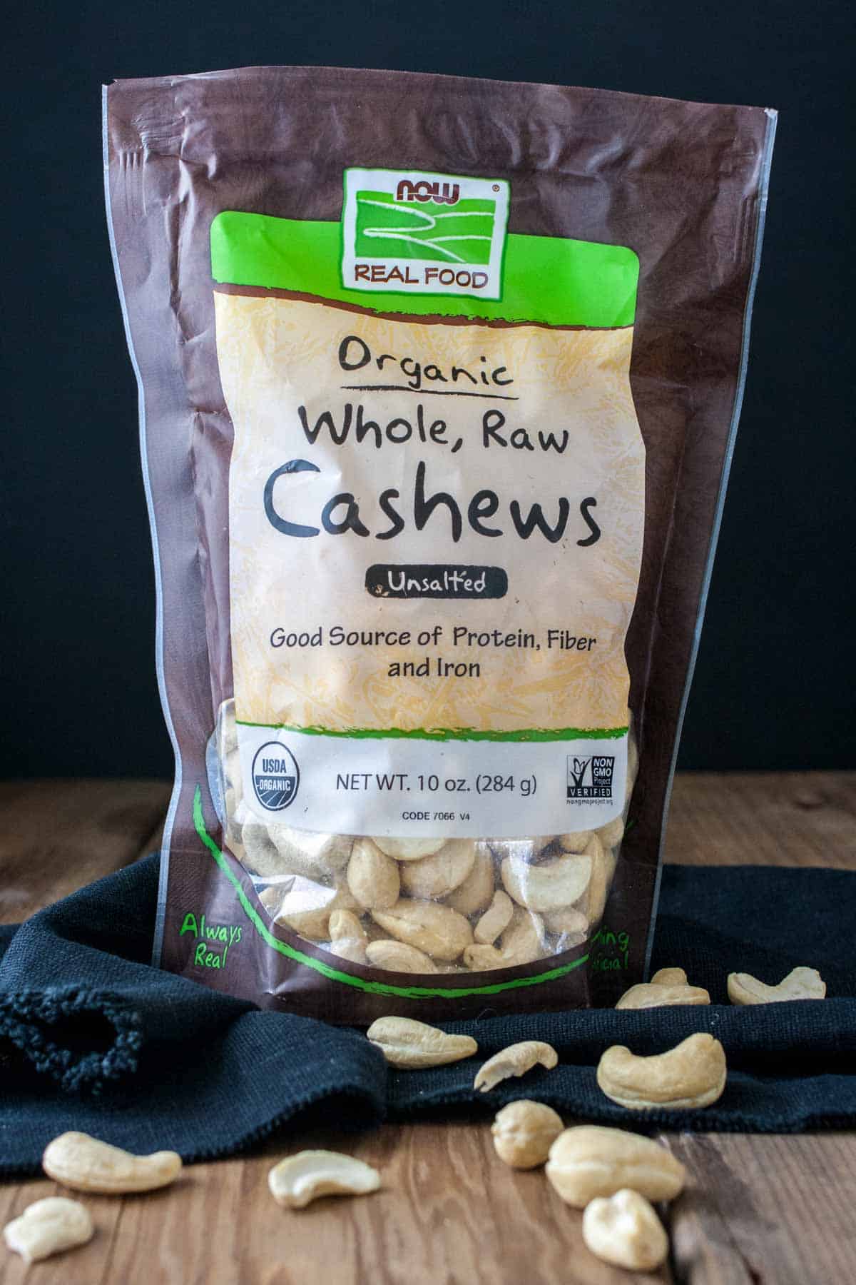 A brown bag of cashews with a tan label and clear window showing the nuts.