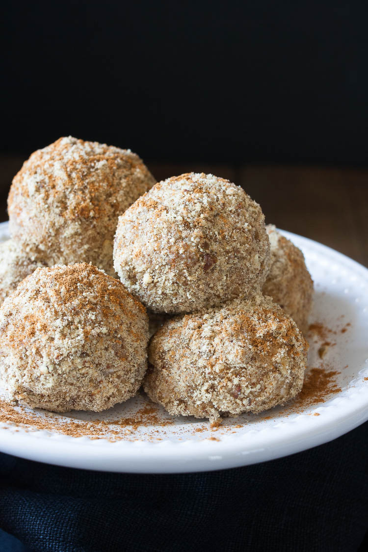 A close up of unfried ice cream balls on a white plate