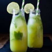 Fresh anti-inflammatory juice in two bottles with straws