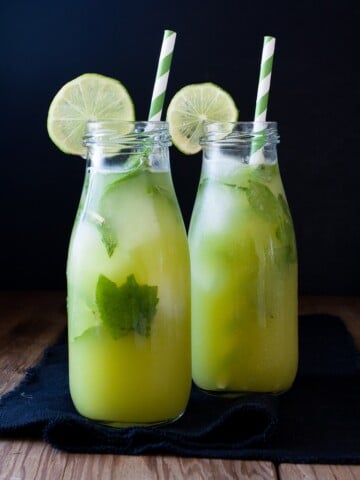 Fresh anti-inflammatory juice in two bottles with straws