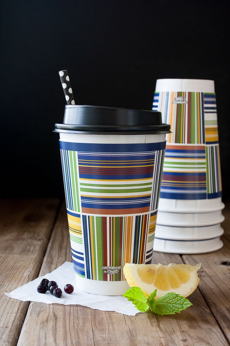 Colorful disposable coffee cup with a black lid