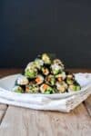 vegan sushi rolls stacked on a white plate