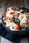 Spaghetti in a bowl with charred tomatoes and peppers