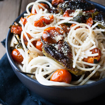 Spaghetti in a bowl with charred tomatoes and peppers