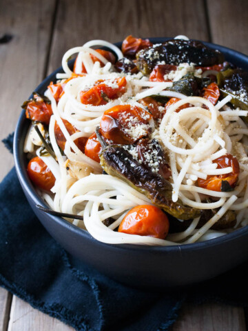 Spaghetti in a bowl with charred tomatoes and peppers