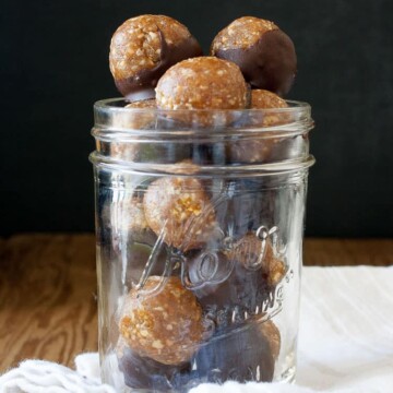 A glass jar filled with Raw Vegan Caramel Peanut Protein Truffles