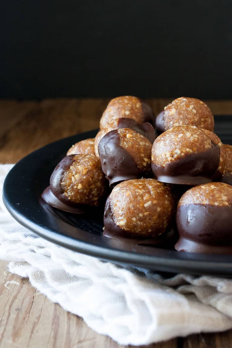 Raw Vegan Caramel Peanut Protein Truffles on a black plate