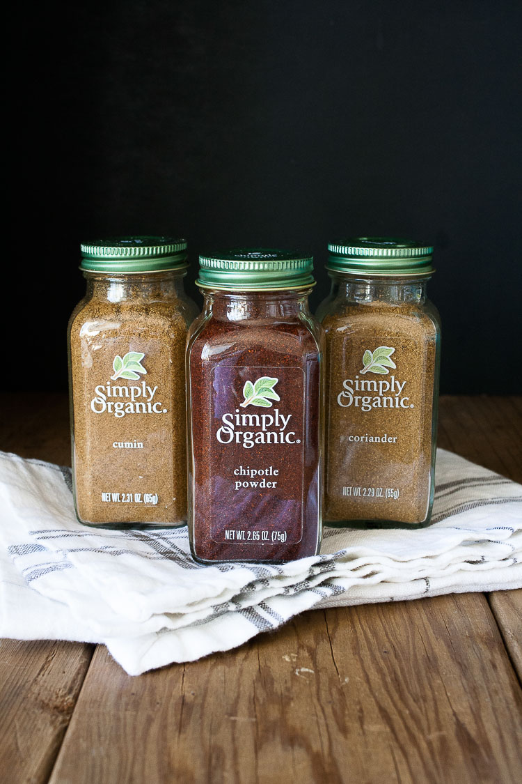 A photo of three simply organic spices sitting on a wooden surface for making vegan Chickpea Soup