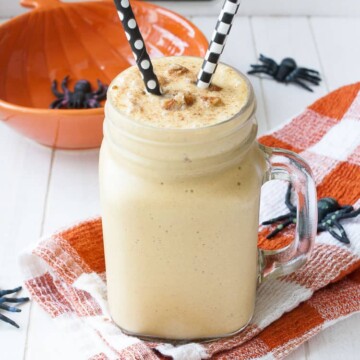 A Vegan Pecan Pumpkin Shake in glass jar with straws