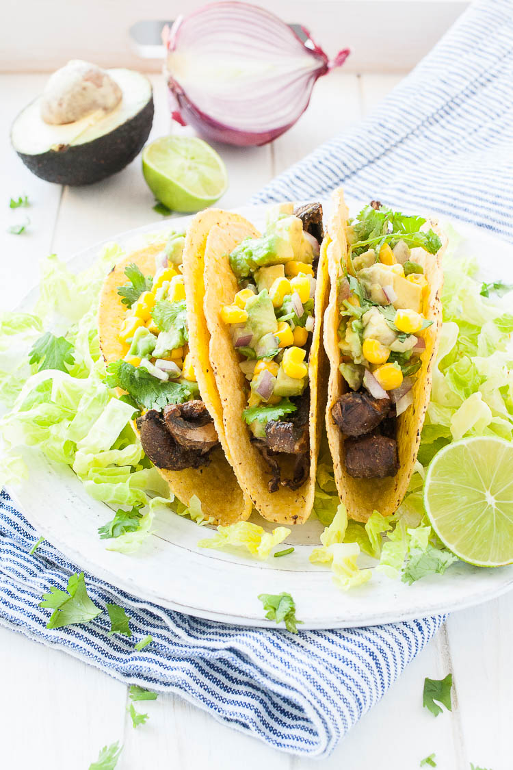 Three Beer-Marinated Portobello Mushroom Tacos on a white plate topped with salsa