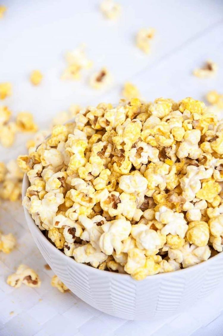 White bowl filled with cheese flavored popcorn