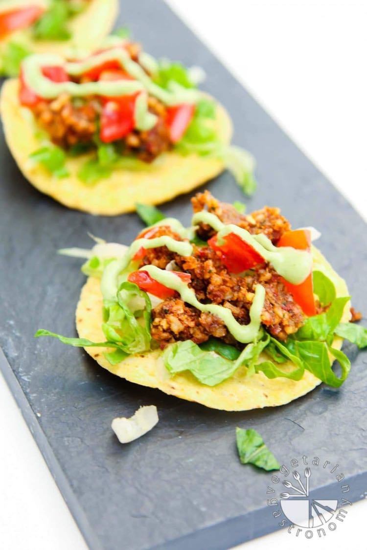 Crispy corn tortilla topped with lettuce, walnut tomato crumble and creamy green sauce