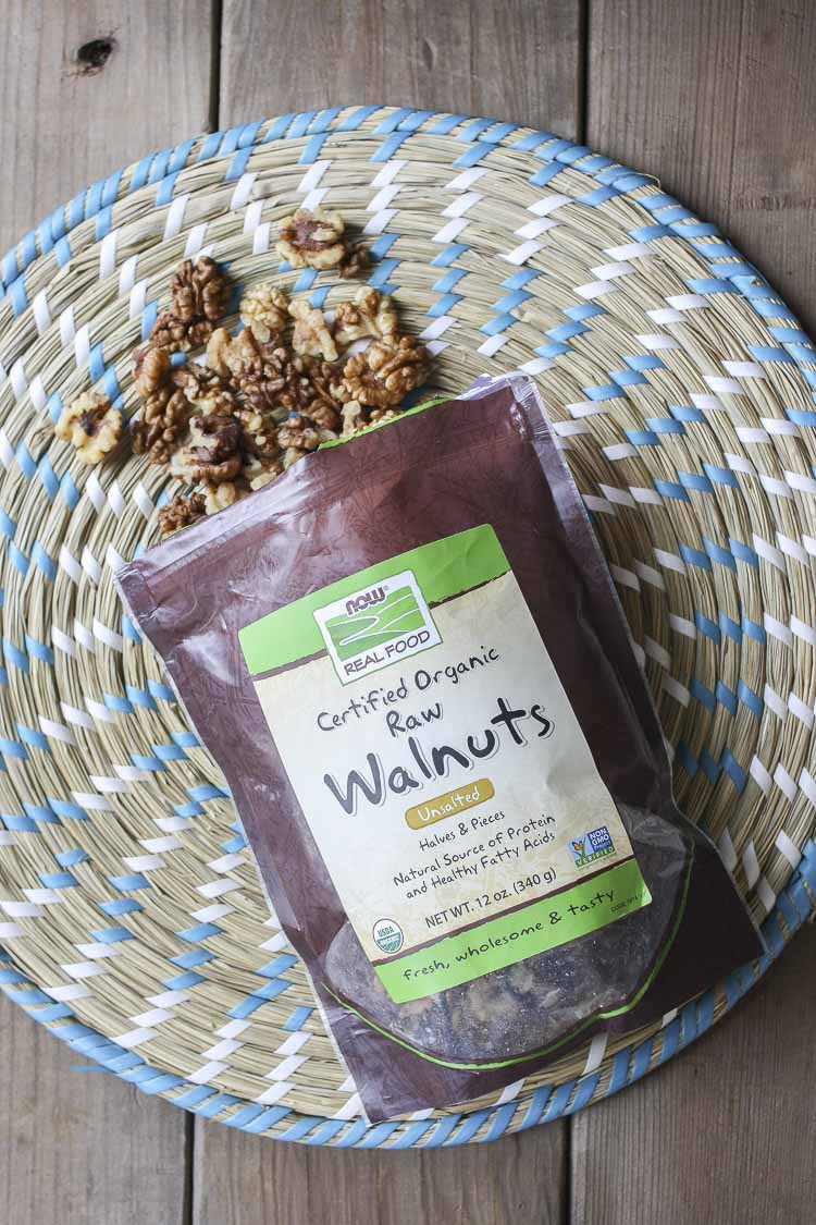 Top view of NOW foods walnuts spilling out of their bag used in a vgean chili cheese dip