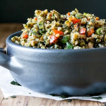 A close up of a blue bowl filled with Stir Fry Cauliflower Rice and veggies