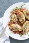 Partially eaten stuffed shells and cauliflower ricotta