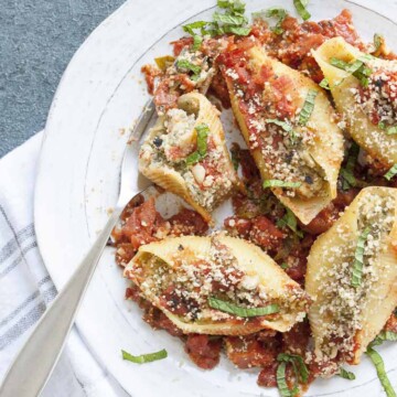 Partially eaten stuffed shells and cauliflower ricotta