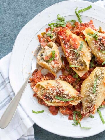 Partially eaten stuffed shells and cauliflower ricotta