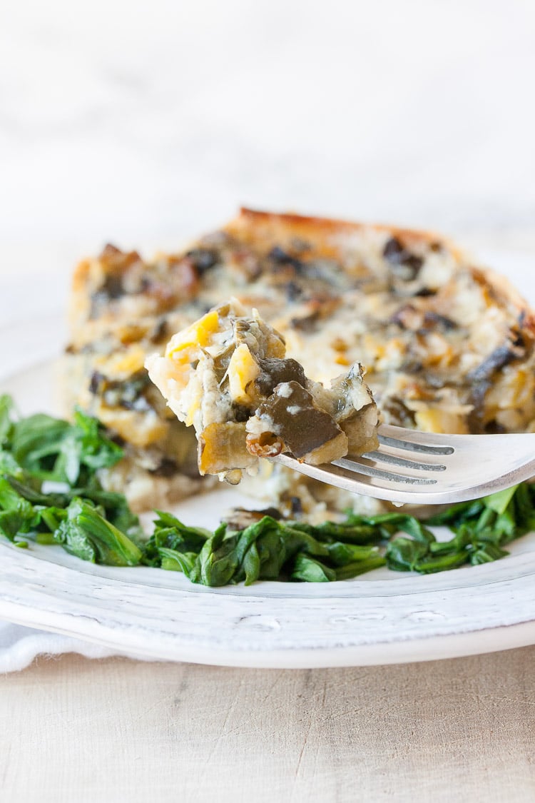 A slice of spinach pie on a fork