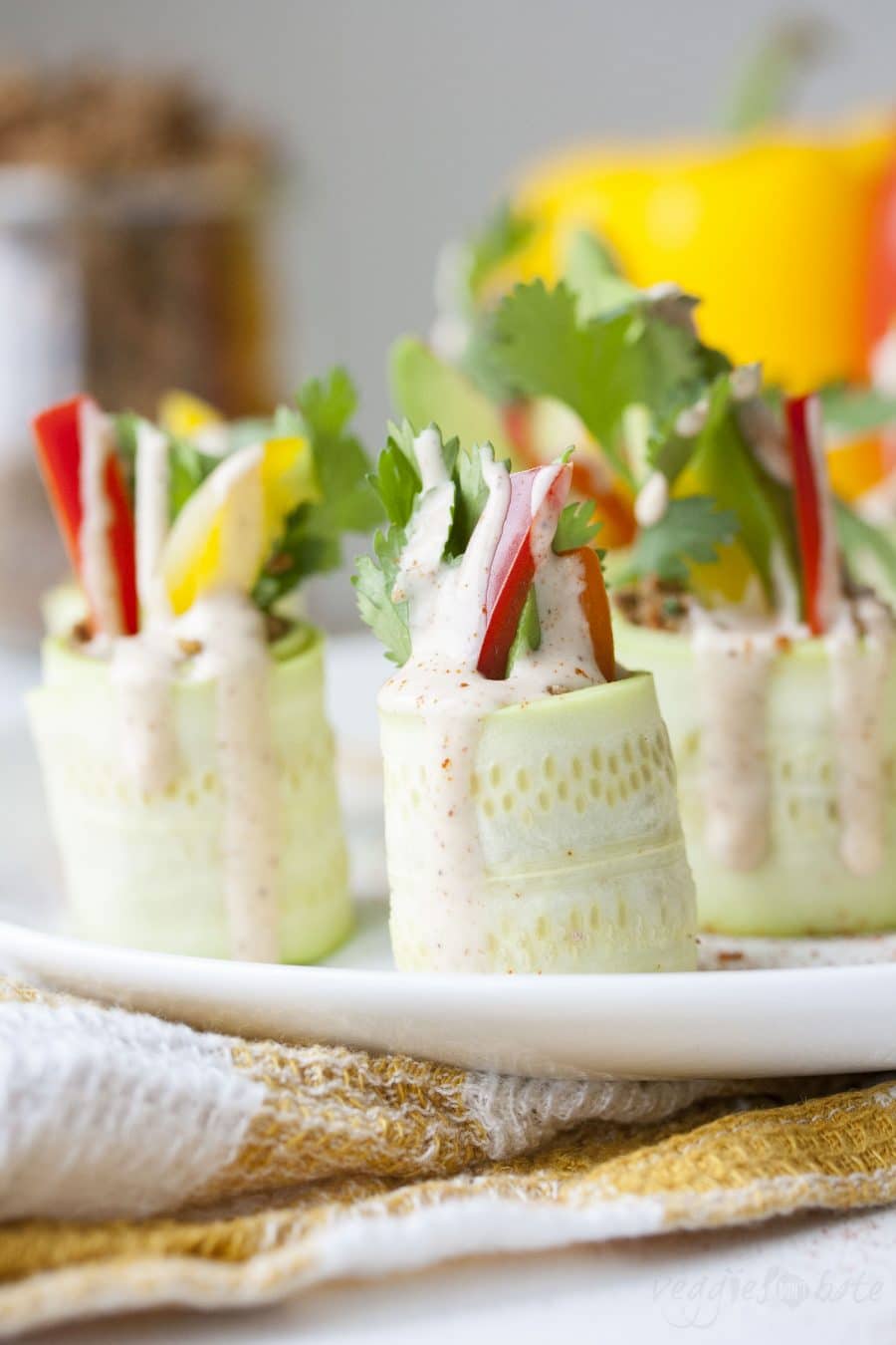 Thinly sliced raw zucchini rolled up with veggies and raw walnut "meat"