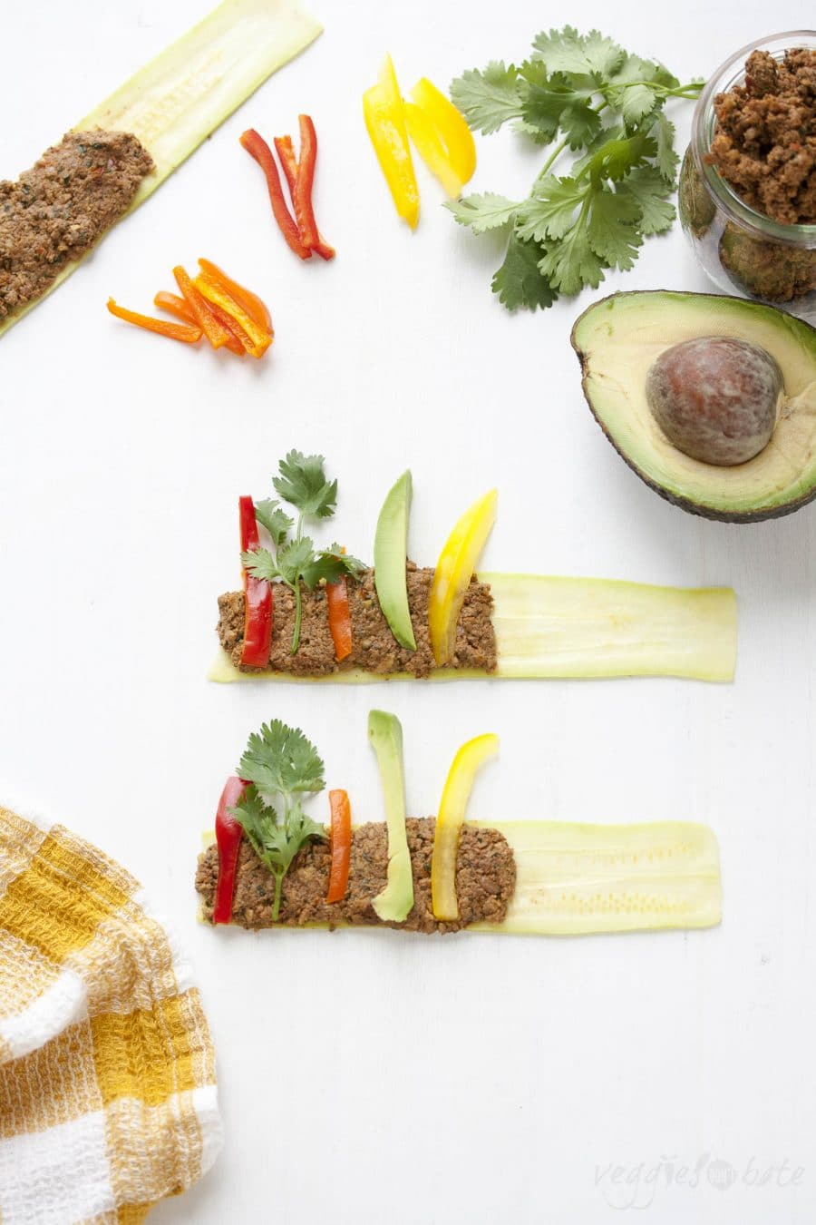 Sliced zucchini covered with raw walnut "meat" and raw veggie slices