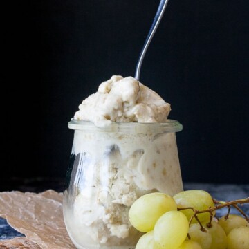 Instant frozen yogurt in a glass jar with a spoon sticking it it