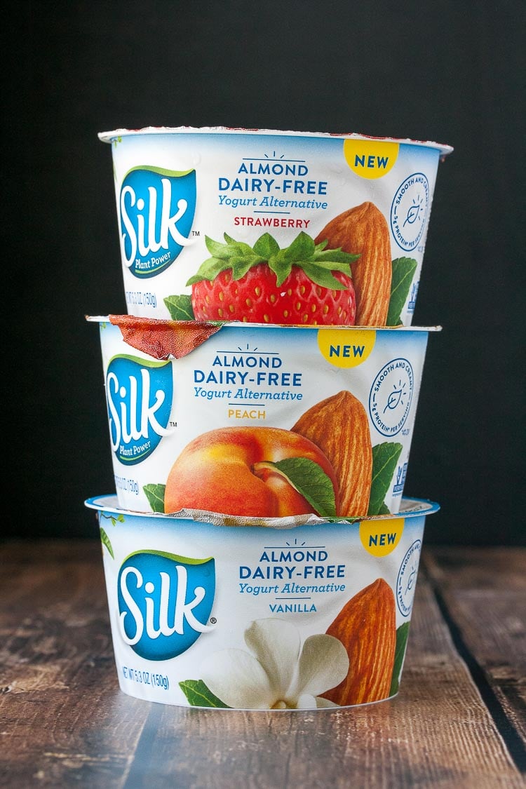 A photo of 3 Silk almond dairy-free yogurts stacked on top of each other