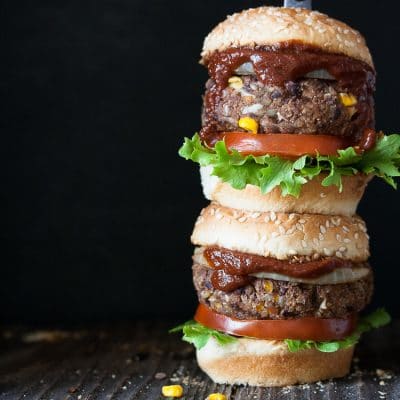 two vegan barbecue burgers stacked on top of each other