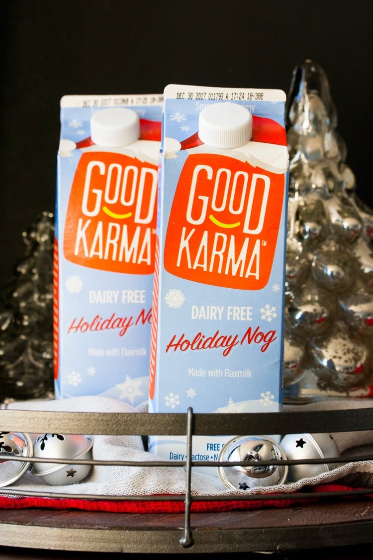 Two cartons of Good Karma holiday nog in a tray with Christmas decorations