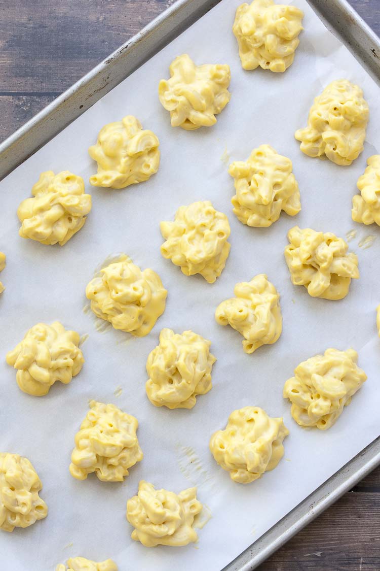 Baking sheet filled with scoops of vegan macaroni and cheese