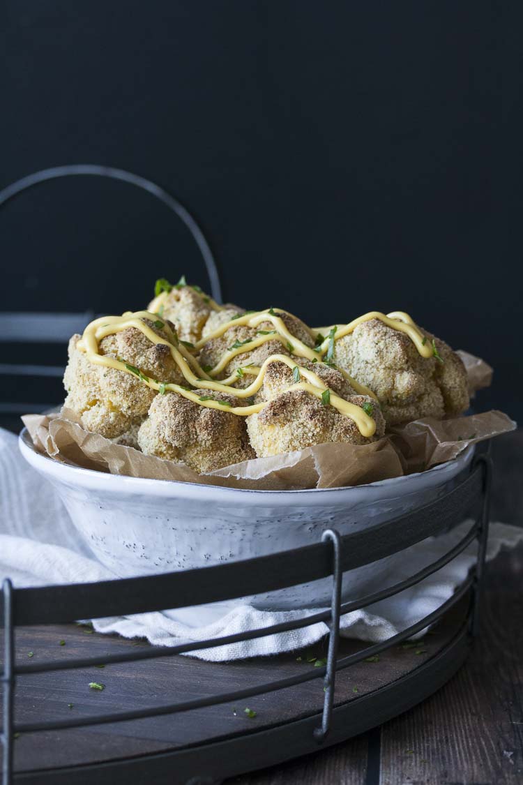 White bowl in metal tray filled with crispy balls of baked mac and cheese