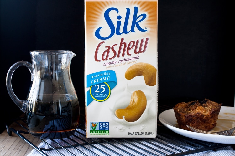 Carton of Silk cashew milk next to jar of maple syrup and French Toast muffin