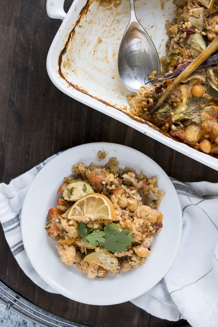 Top view of a white plate with harissa flavored vegetables and rice