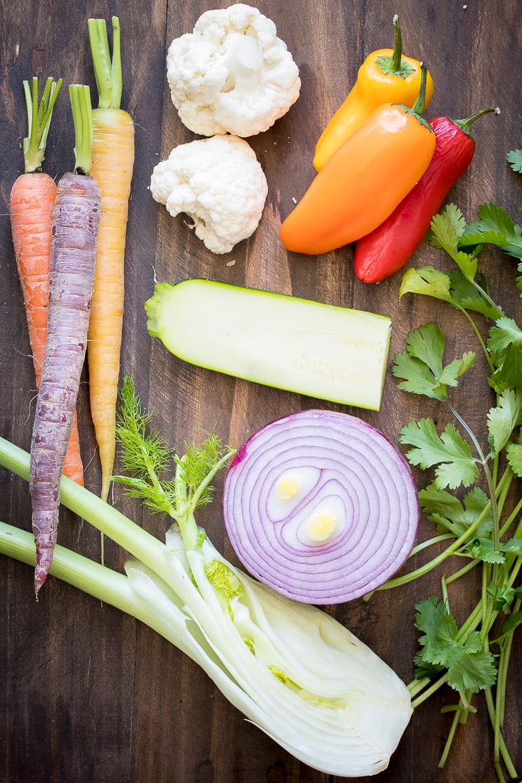 Top view of different vegetables on a wooden table