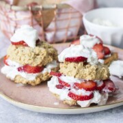 Front view of two strawberry shortcakes on a pink plate