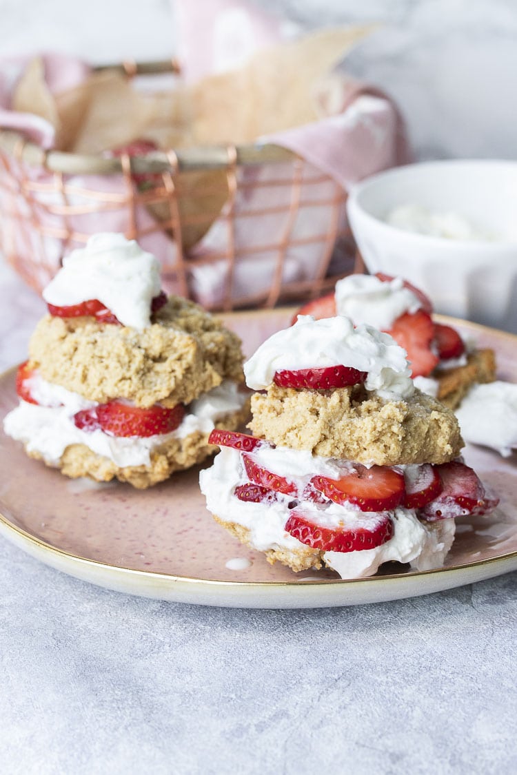 Front view of two strawberry shortcakes on a pink plate