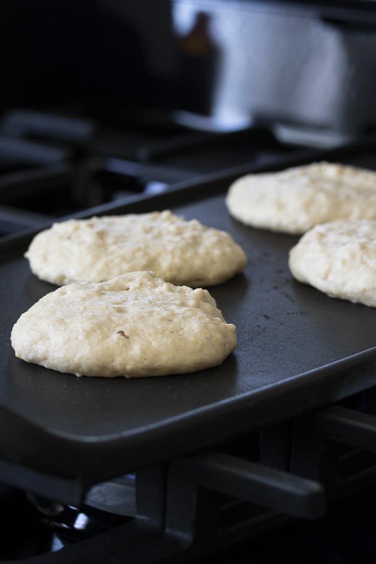 Black griddle on stiff top with pancakes cooking on top