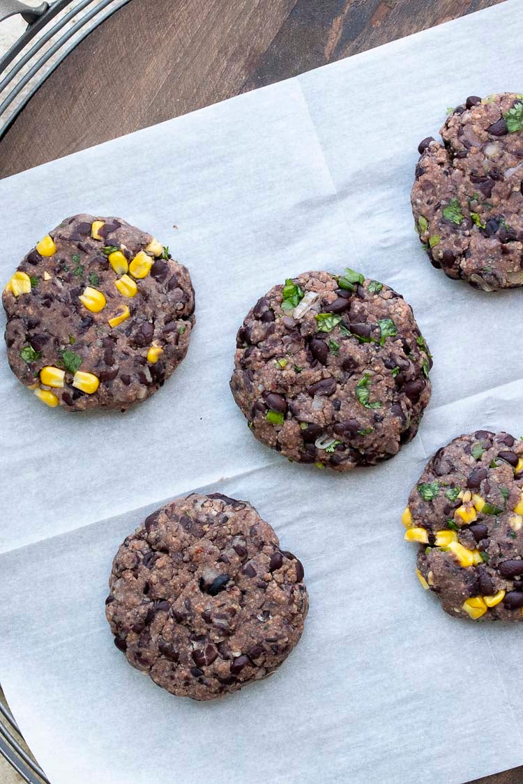 Top view of parchment paper with black bean burger patties on top