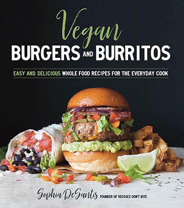 Cookbook cover with a burrito, burger and fries on a white table with a black background