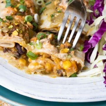 Fork getting a bit of pumpkin enchiladas with black beans