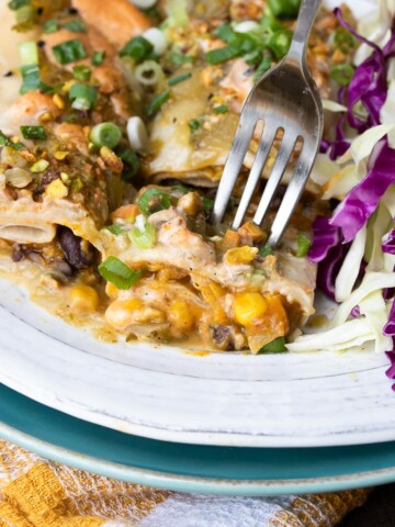 Fork getting a bit of pumpkin enchiladas with black beans