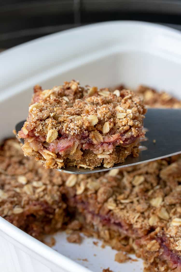 Metal spatula taking out a piece of cranberry crumble oatmeal bars