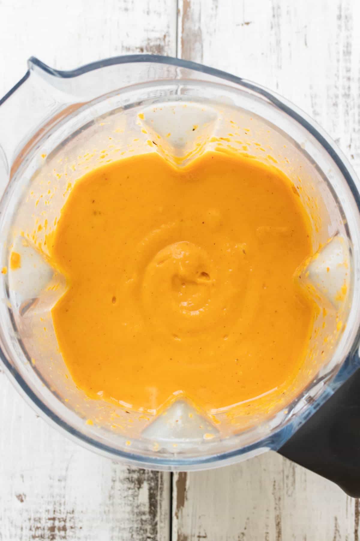 Top view of vegan butternut squash soup pureed in a blender