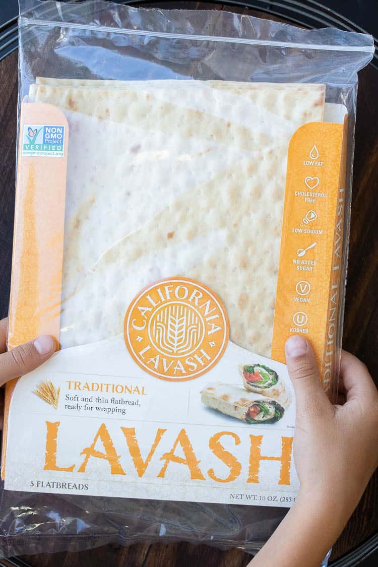 Hands holding a yellow package of lavash flatbread