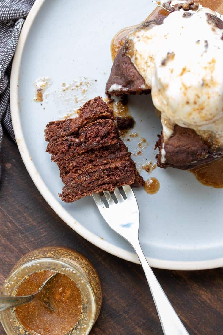 Fork laying on a gray plate filled with chocolate pancakes 