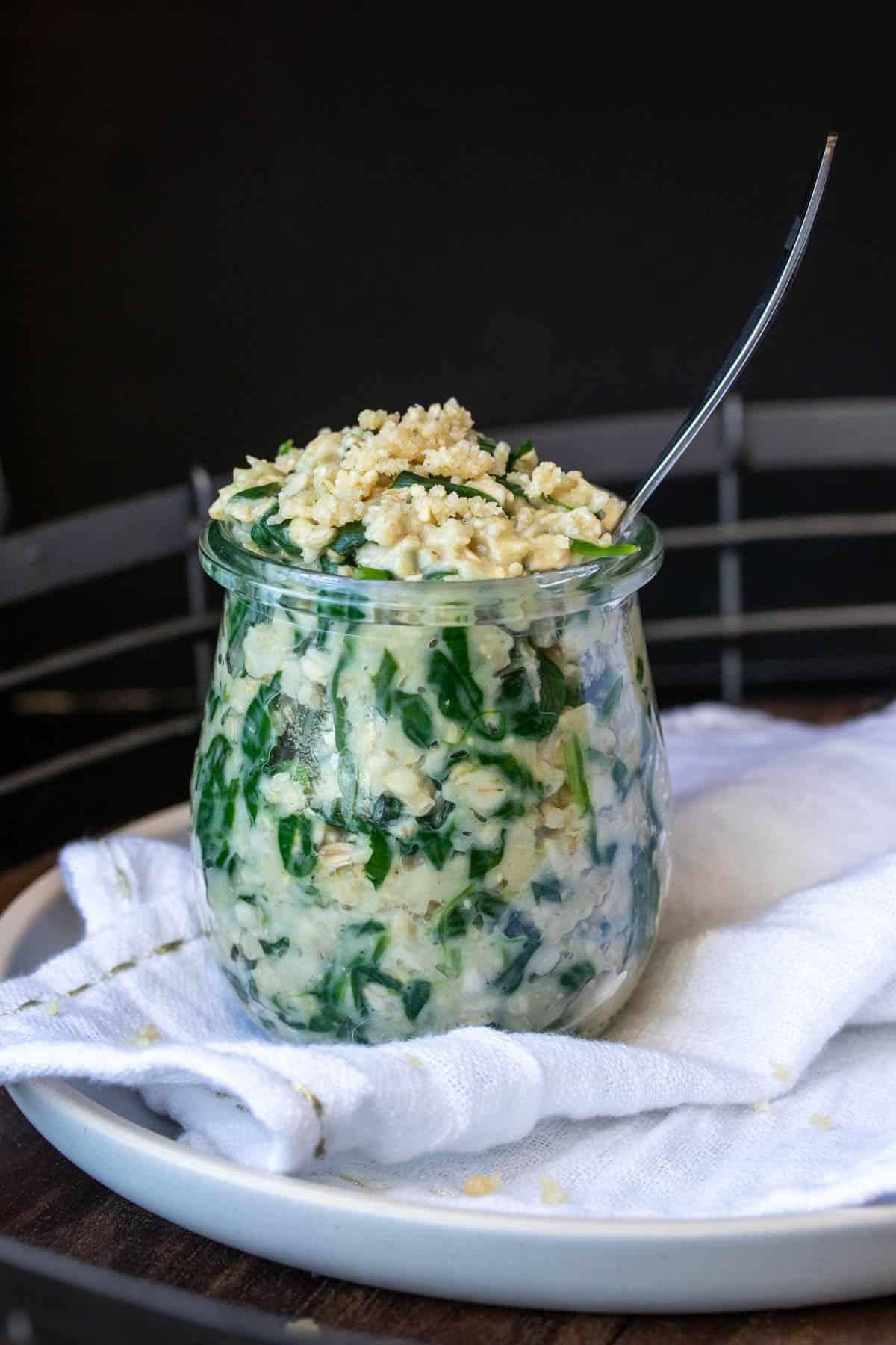 Savory spinach and parmesan oats in a glass jar